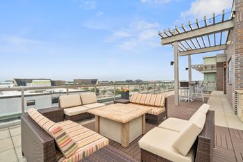 a rooftop terrace with couches and a table